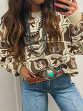Graphic Round Neck Long Sleeve Sweater in beige-brown knit with bold pattern, styled with blue jeans.