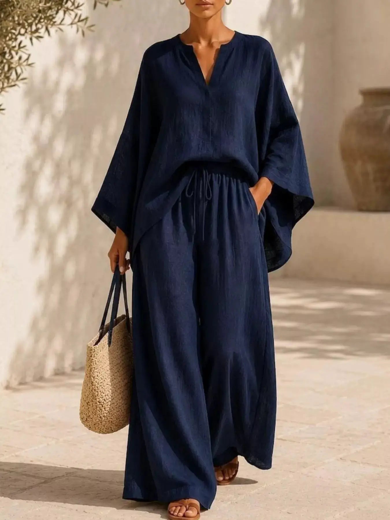 Plus-size notched long-sleeve top and wide-leg navy pants set.