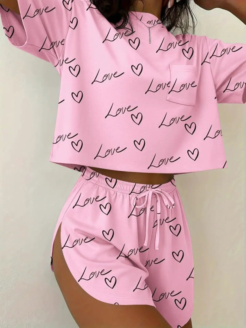 Two-piece pink printed round-neck tee and shorts set with love hearts by Trendsi