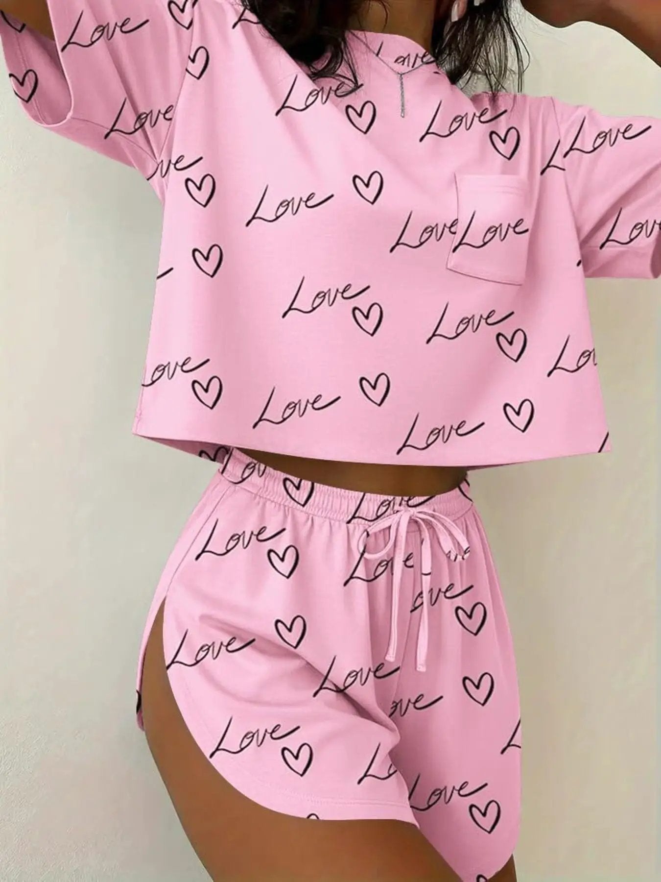 Two-piece pink printed round-neck tee and shorts set with love hearts by Trendsi