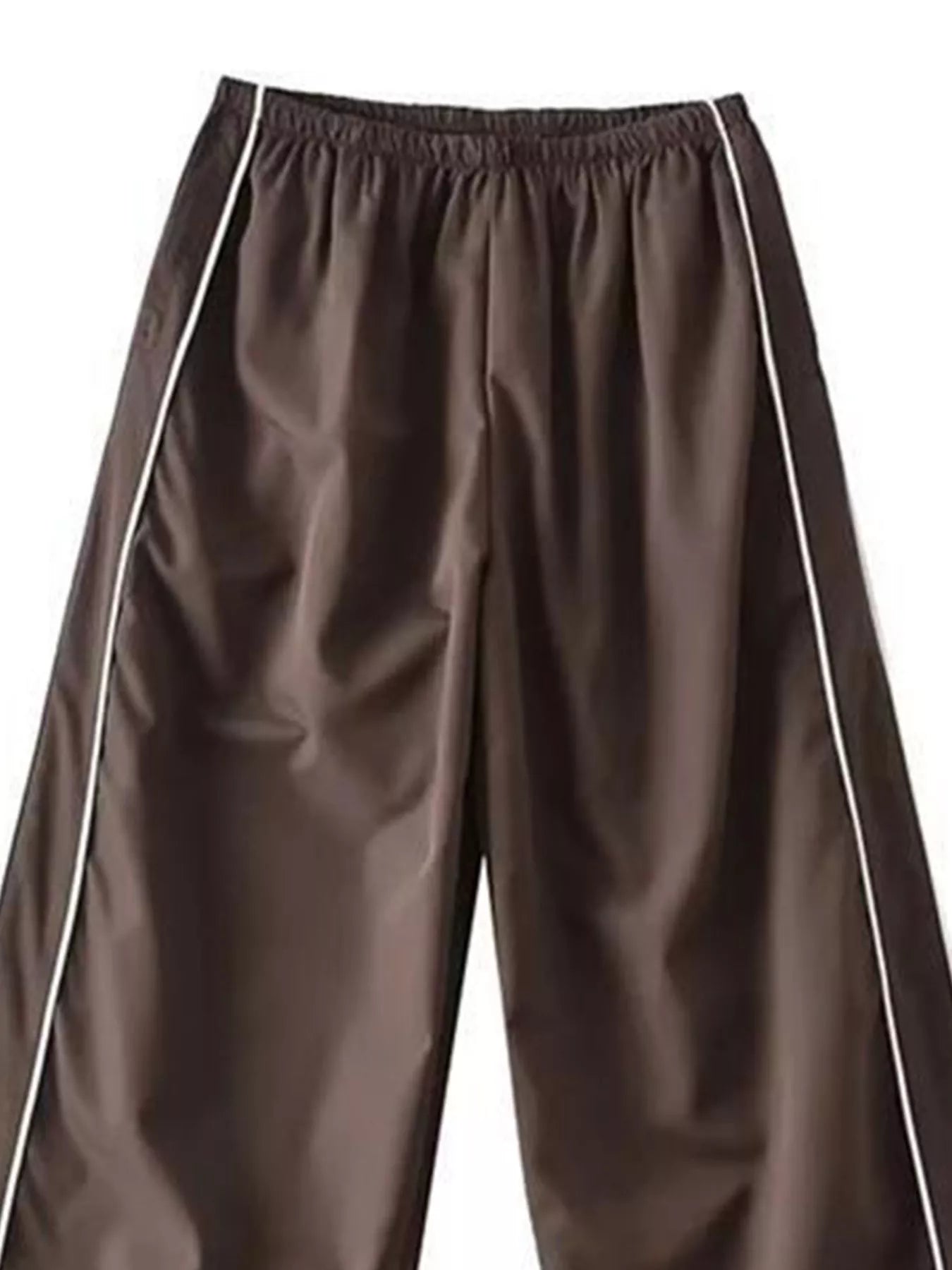 Elastic waist wide-leg pants in brown faux leather with white piping along outer seams.