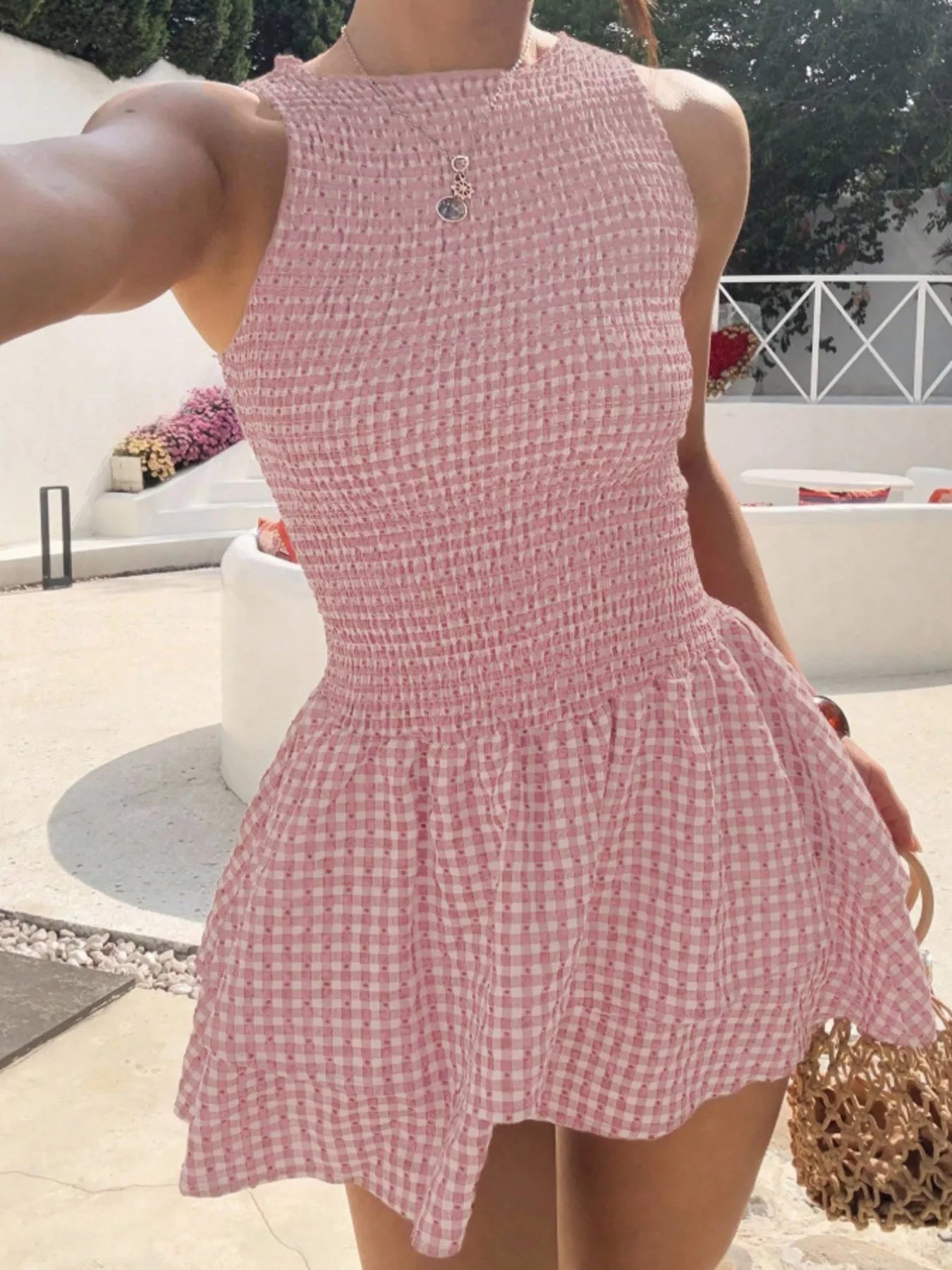 Gingham smocked mini dress in pink and white check by Trendsi, sleeveless with smocked waist.
