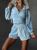 Two-piece light blue zip-up hooded activewear set with matching shorts, white drawstrings and crochet-trim hems.