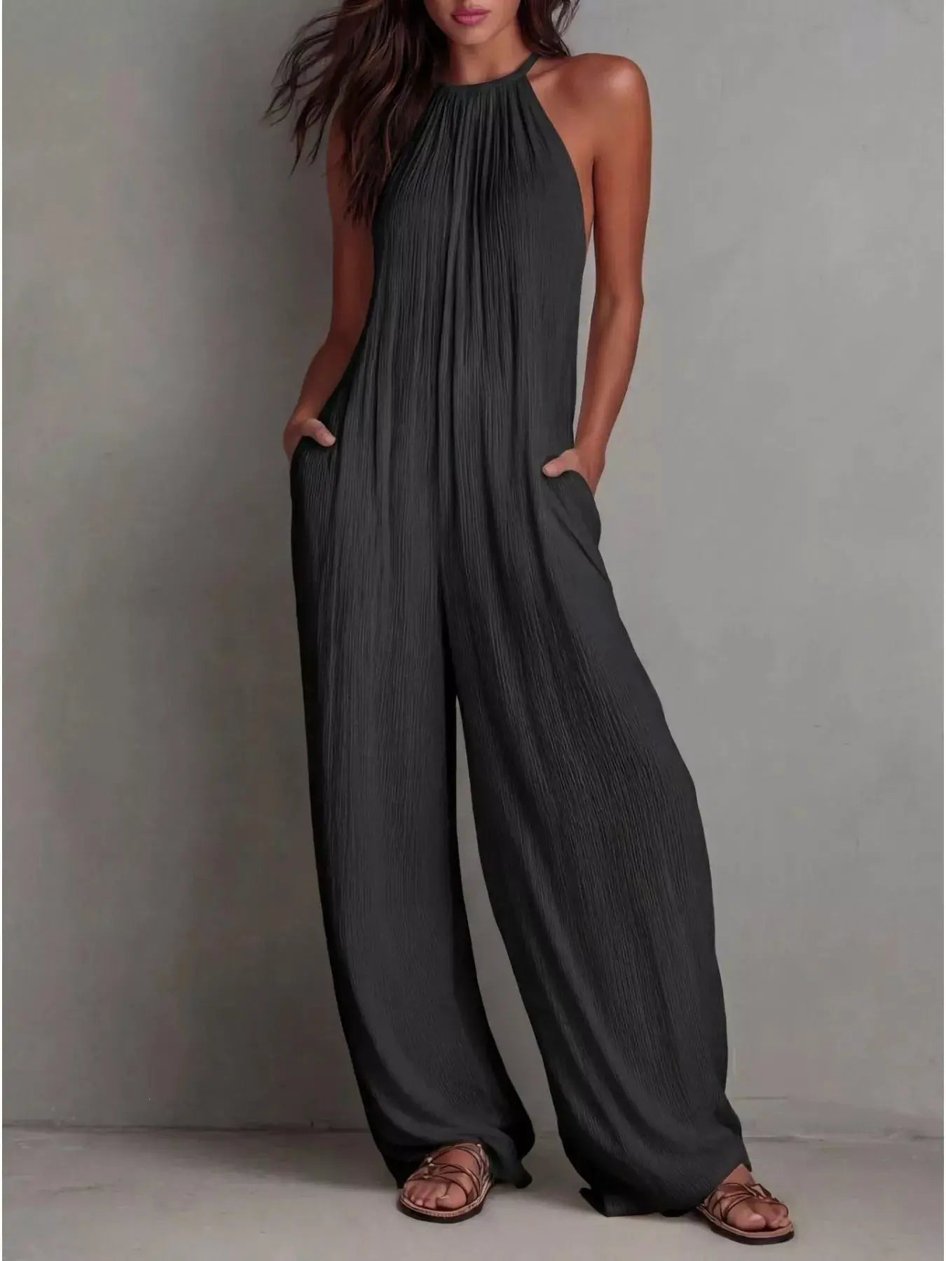 Sleeveless Wide-Leg Jumpsuit in charcoal with pleated texture, pockets and zipper