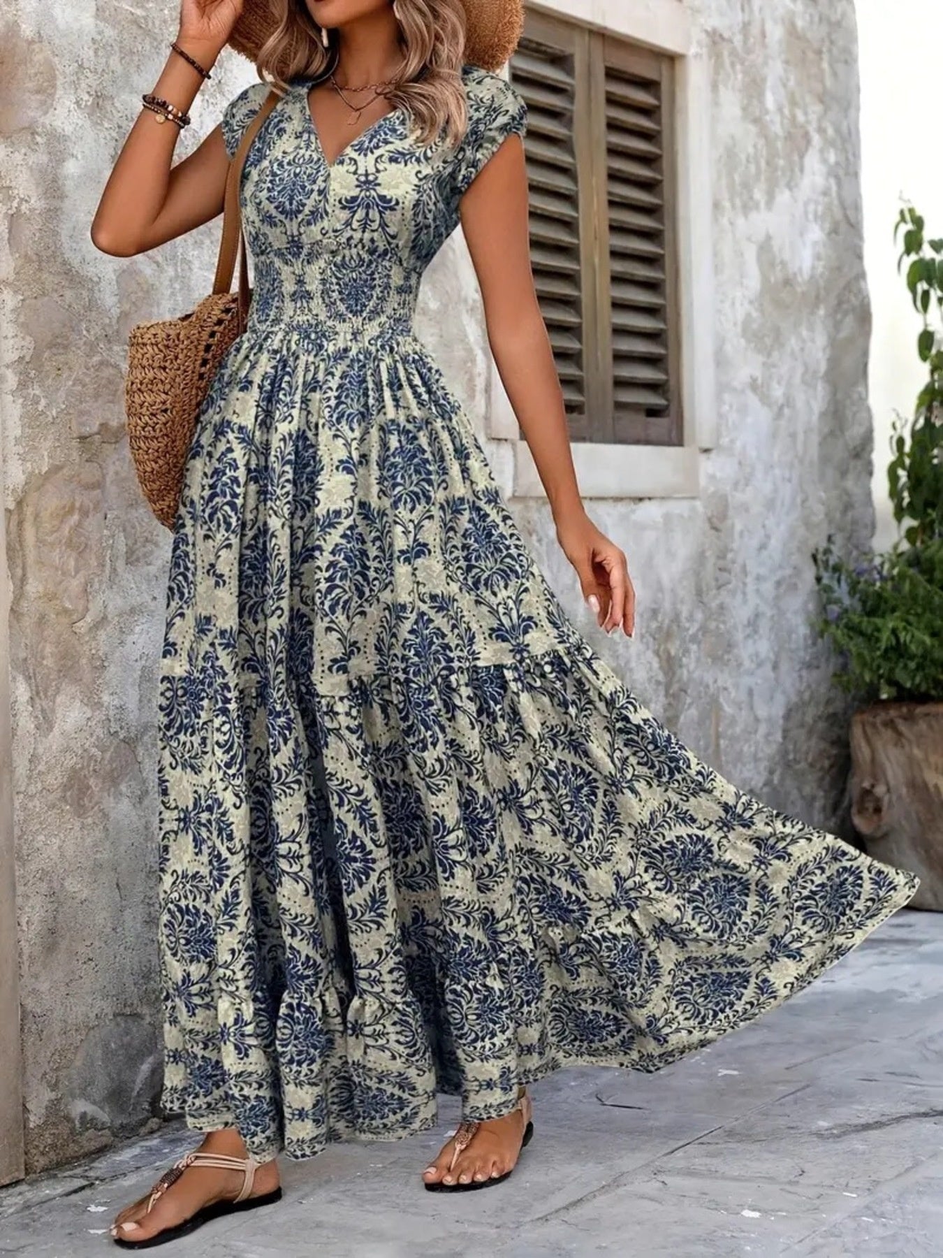 Printed cap-sleeve maxi dress in blue botanical print on ivory, smocked bodice and tiered flowing skirt