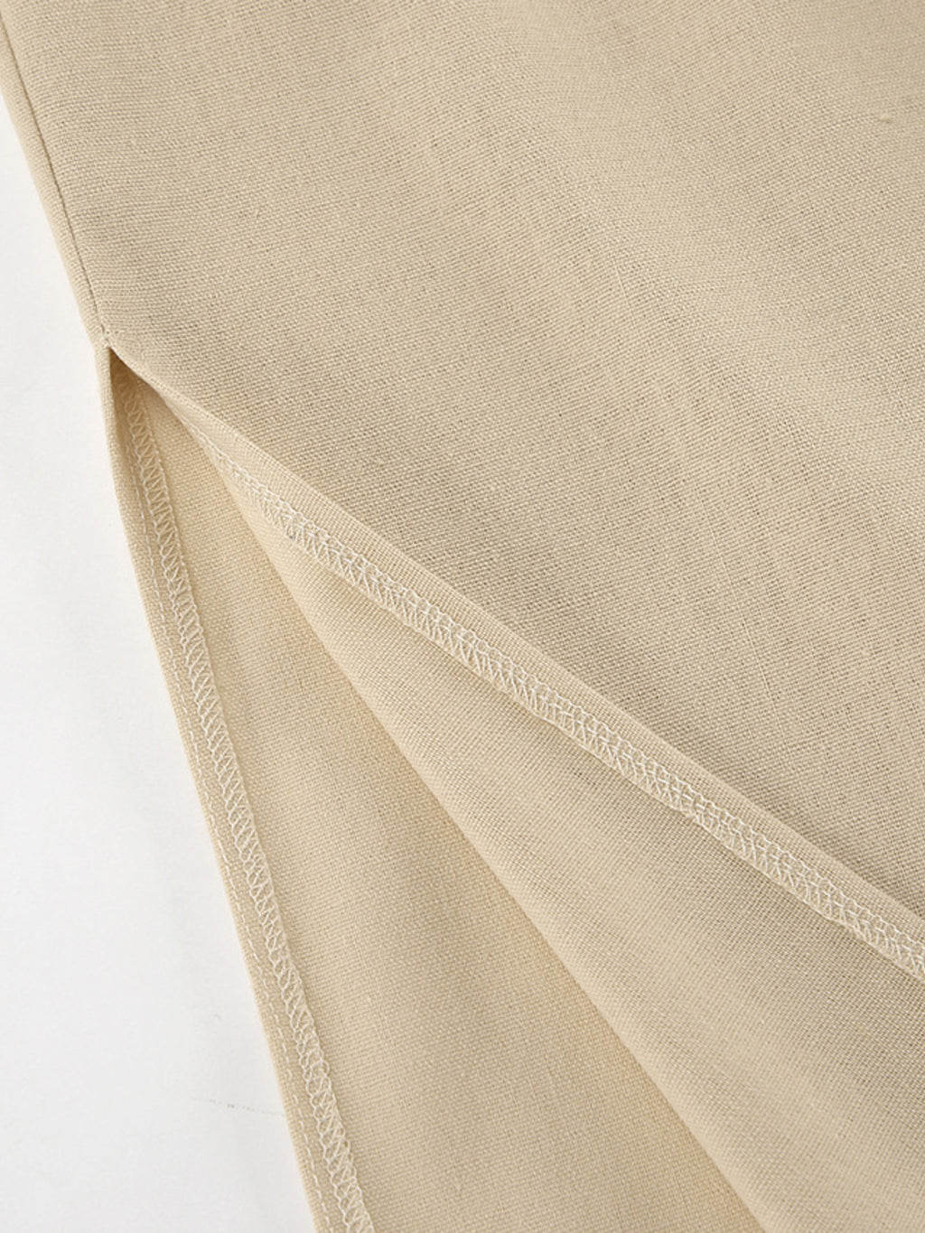 Sleeveless crop top and slit pants set in beige fabric; textured weave