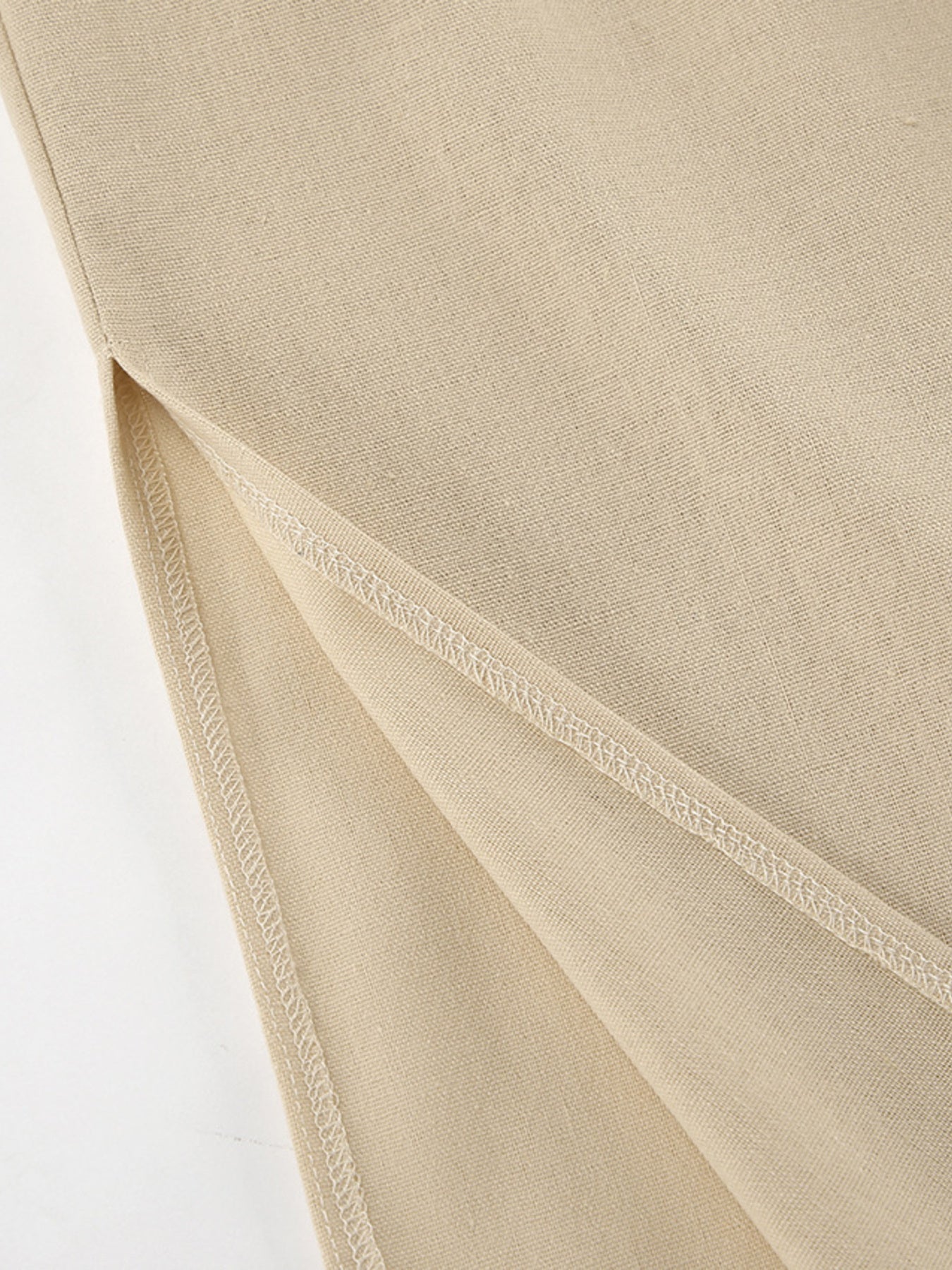 Sleeveless crop top and slit pants set in beige fabric; textured weave