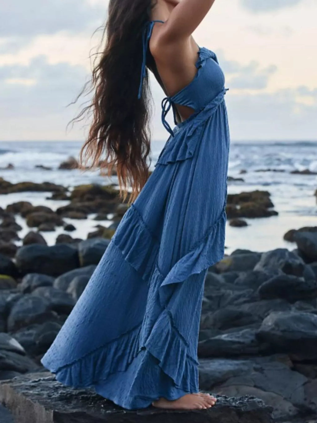 Ruffled Halter Neck Maxi Dress in blue with tiered ruffles by the sea