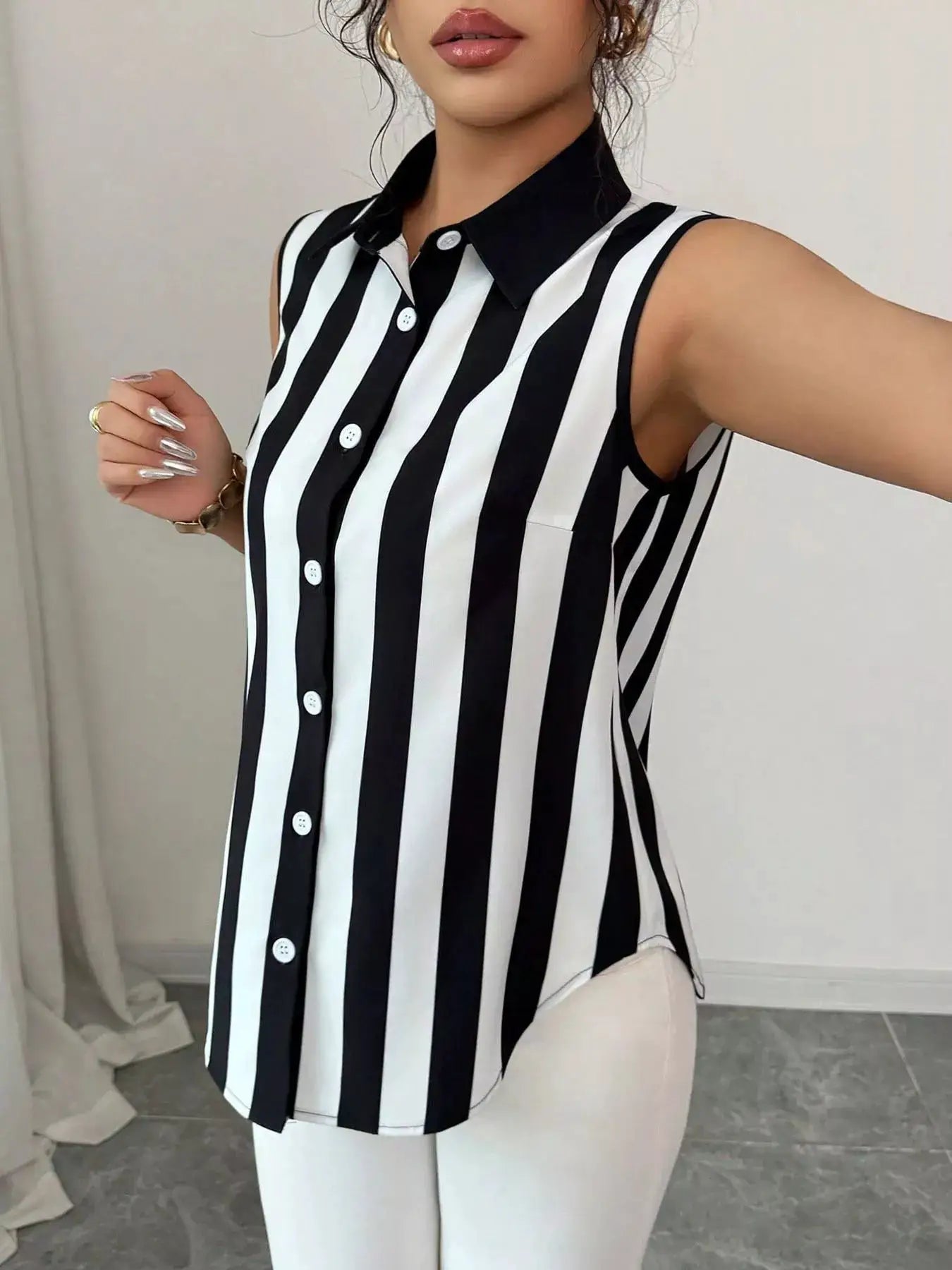 Button Up Sleeveless Shirt by Belle Bijouix in black and white vertical stripes.