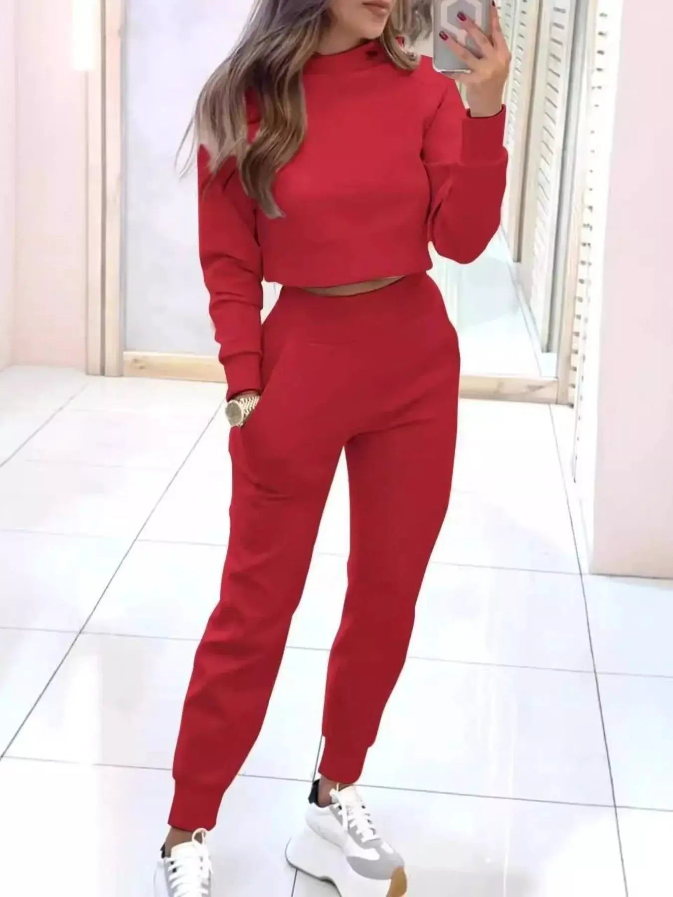 Casual Chic Cropped Sweatshirt and Jogger Set in red; pocketed activewear on model with white sneakers.