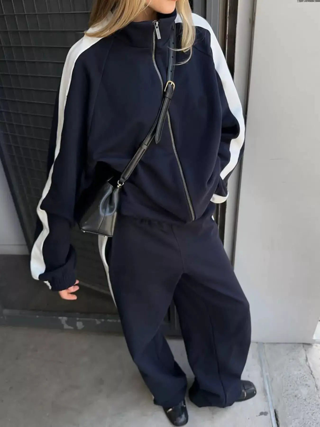 Two-Piece zip-up long sleeve outerwear and pants set in navy with white stripe sleeves