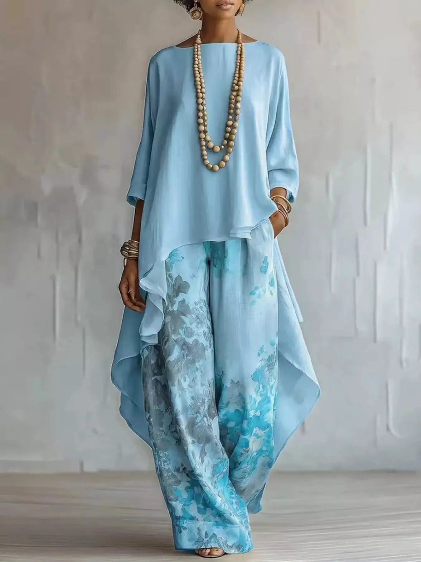 Asymmetrical Hem Top and Floral Pants 2-piece outfit set by Belle Bijouix in light blue with layered bead necklaces.