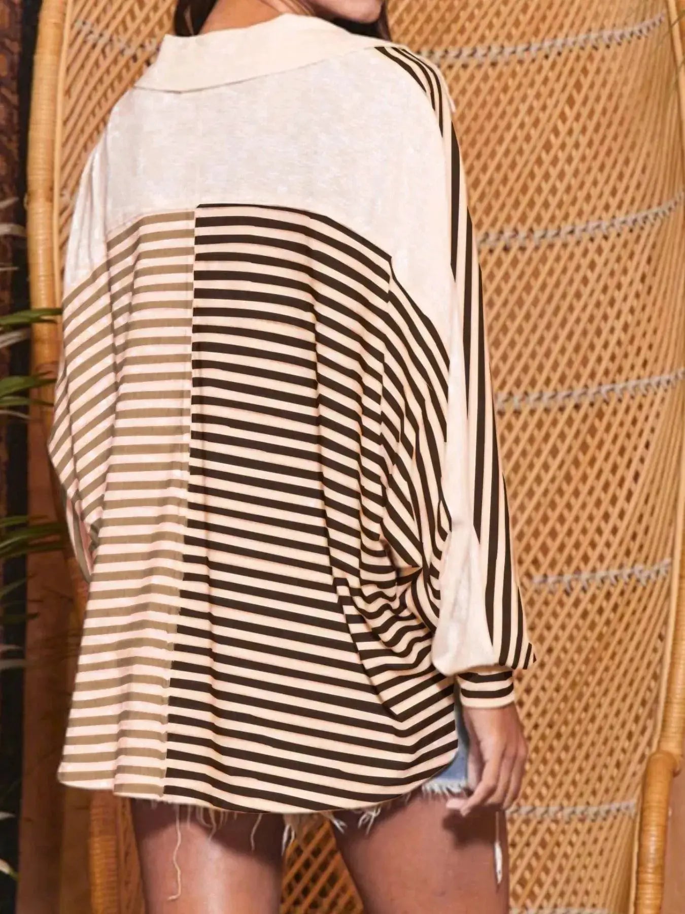 Striped oversized half-button sweatshirt top; black and white stripes, back view