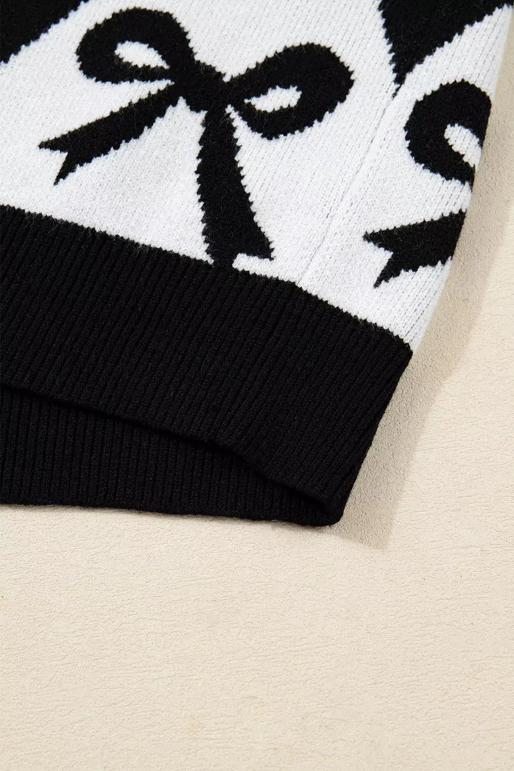 Bow Pattern Long Sleeve Contrast Sweater by Belle Bijouix, black and white knit with bow motif and ribbed hem