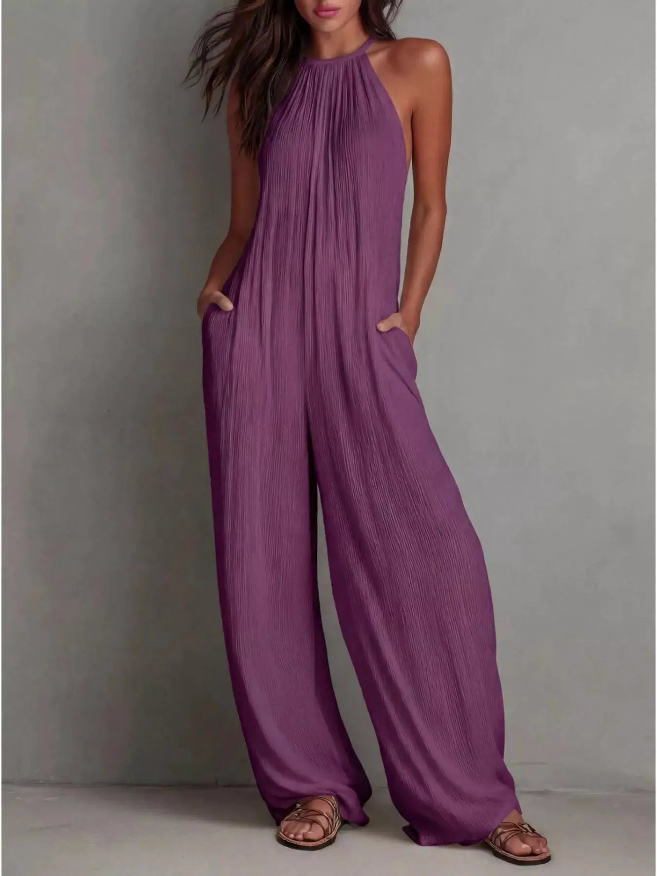 Sleeveless wide-leg jumpsuit in purple with side pockets and zipper.