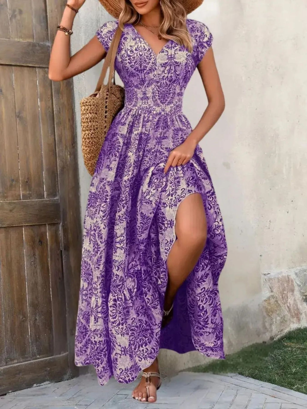 Printed cap-sleeve maxi dress in purple and white floral pattern with a smocked waist and tiered skirt.