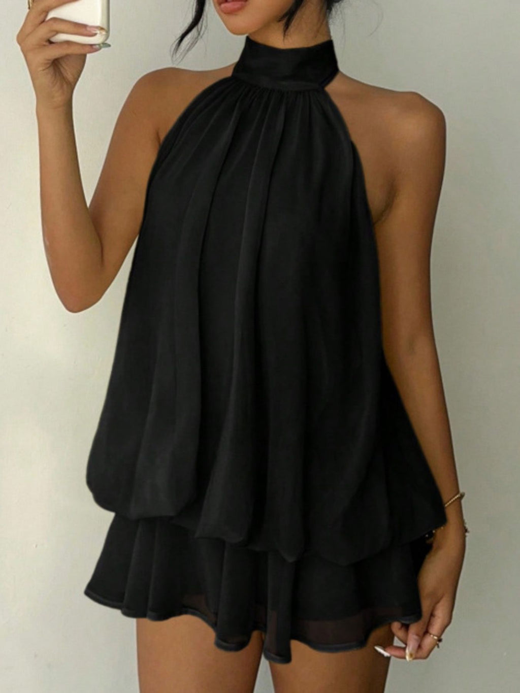 Halter neck layered mini dress in black with tiered ruffles.