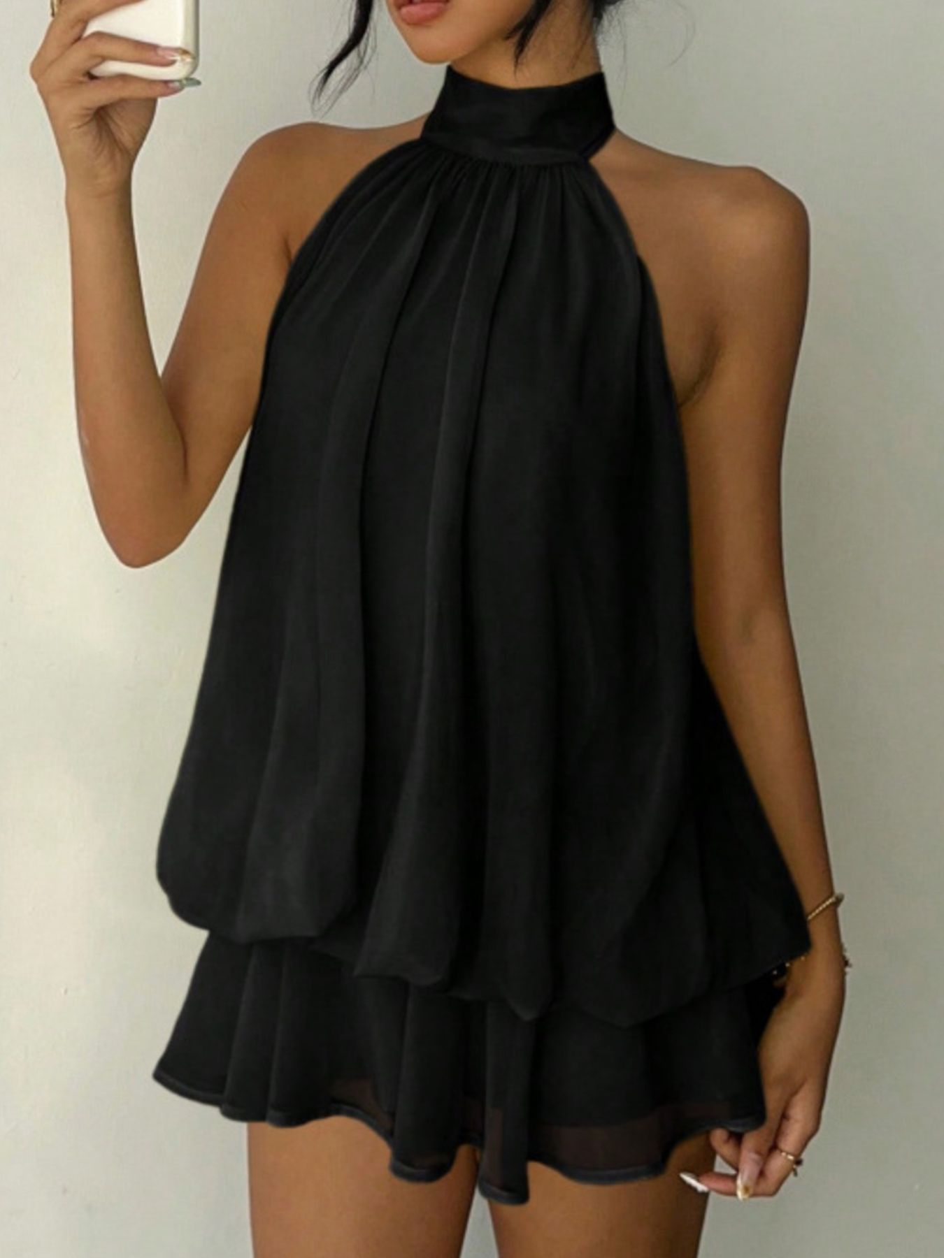 Halter neck layered mini dress in black with tiered ruffles.