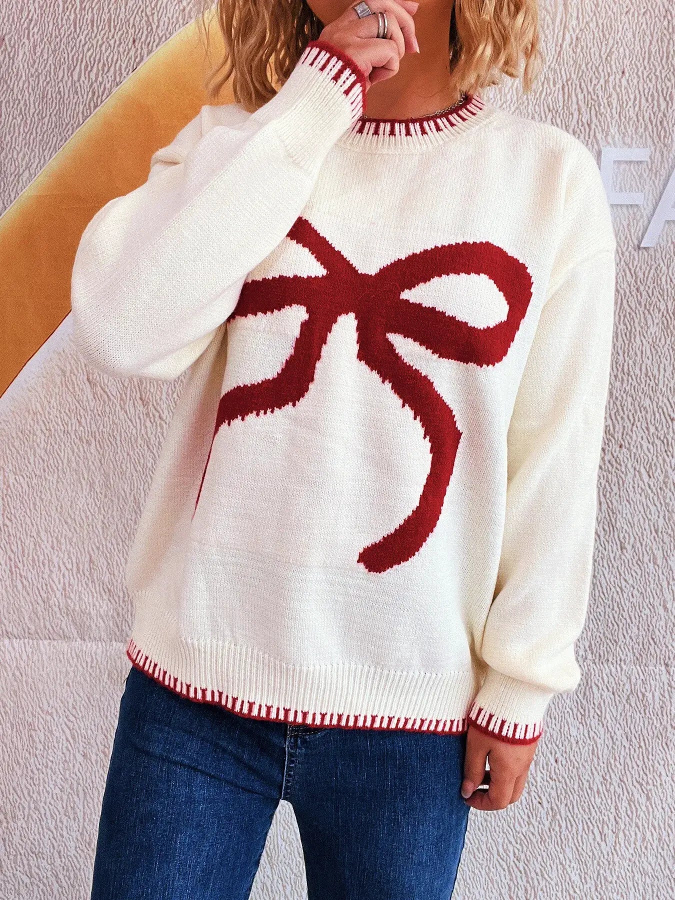 Bow Pattern Round Neck Sweater in white knit with red bow motif