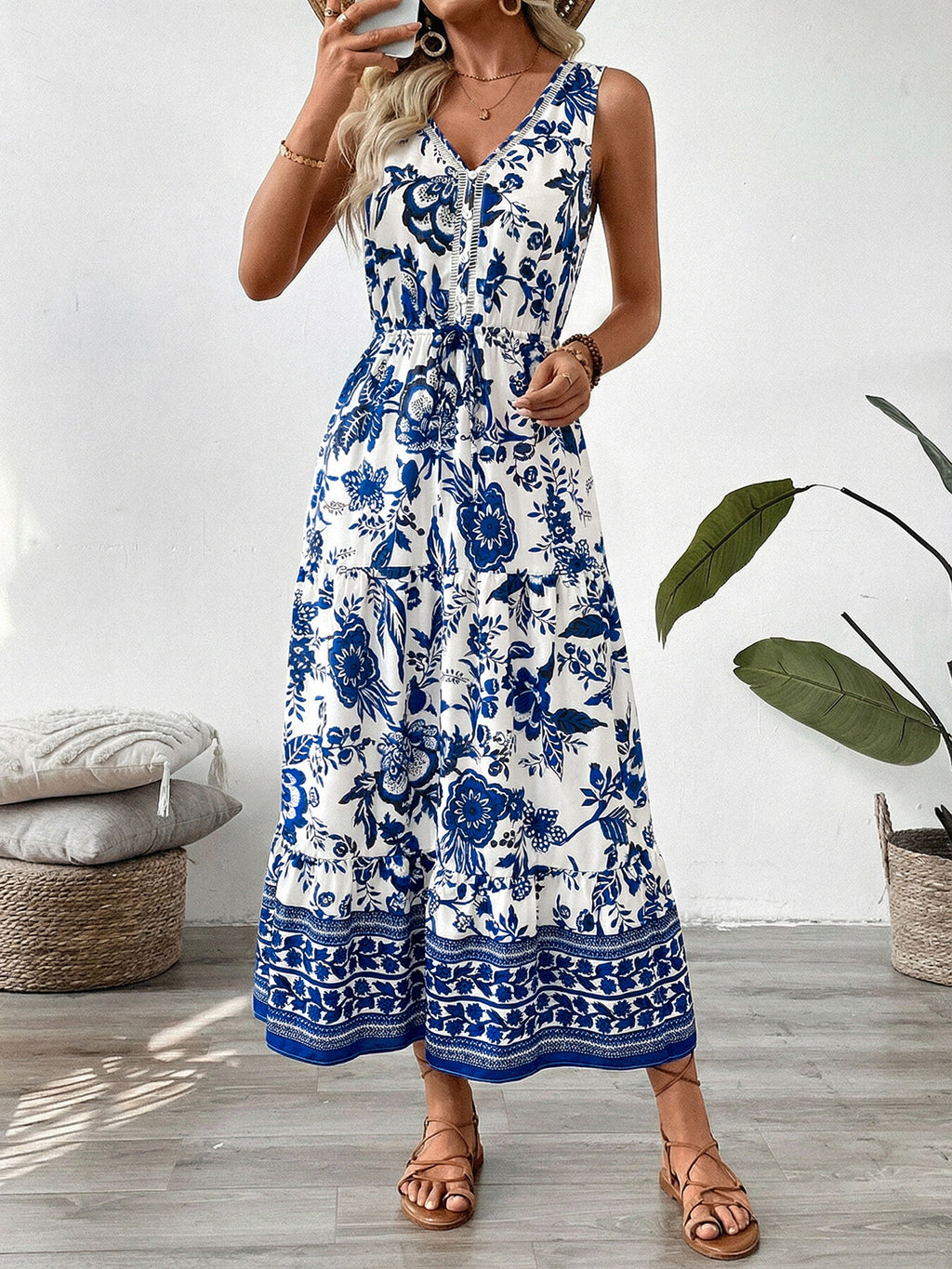 Floral Print Sleeveless V-neck Midi Dress with buttoned front, tiered skirt, white with blue botanical print.