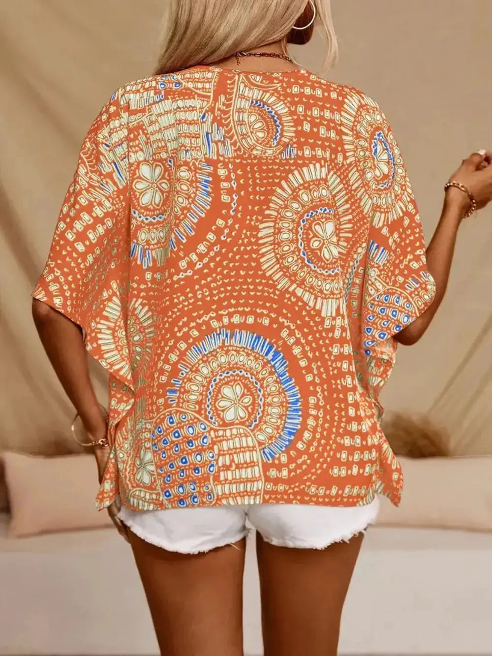 Printed V-Neck Half-Sleeve Top in orange with white-blue circular patterns, sheer loose-fit fabric