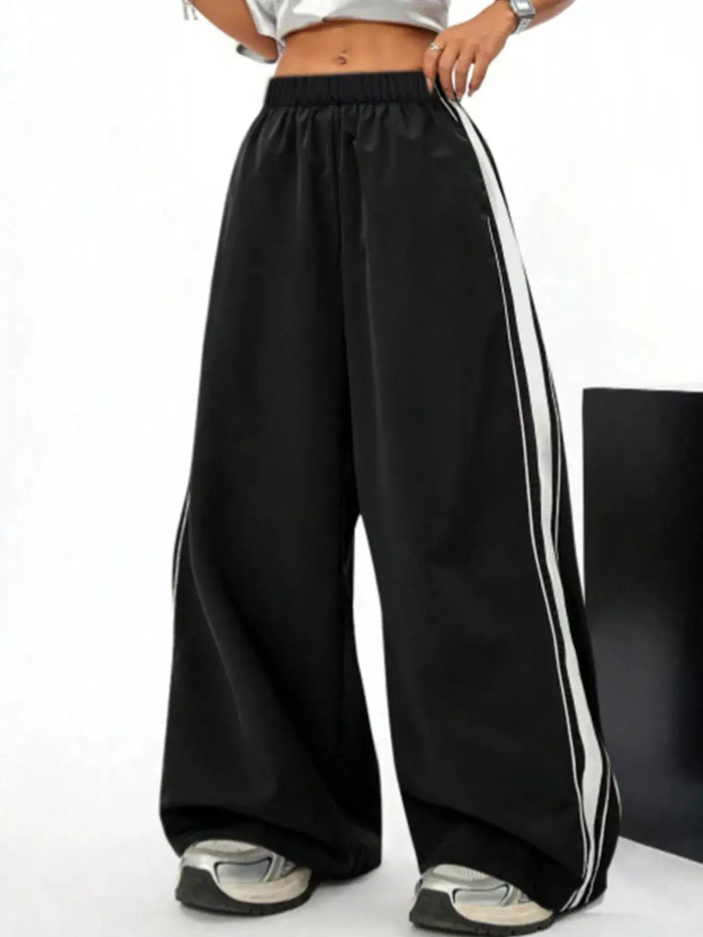 Wide-leg striped pants by Bellebijouix, black activewear with white side stripes, elastic waistband