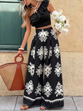 One-Shoulder Ruffled Crop Top and Wide-Leg Printed Pants Set in black with white ornate print.