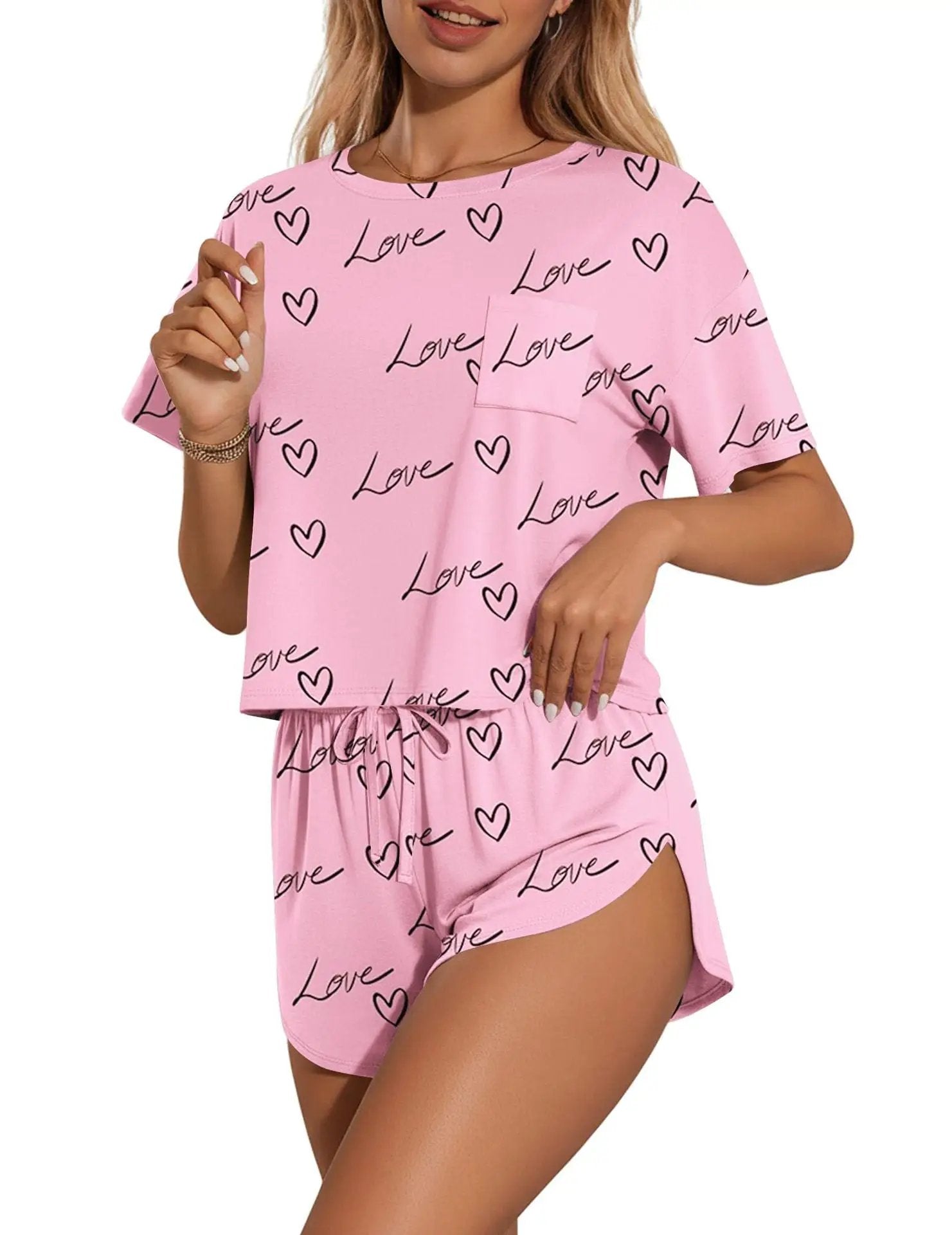 Printed pink round-neck tee and shorts set with black love hearts pattern, by Trendsi