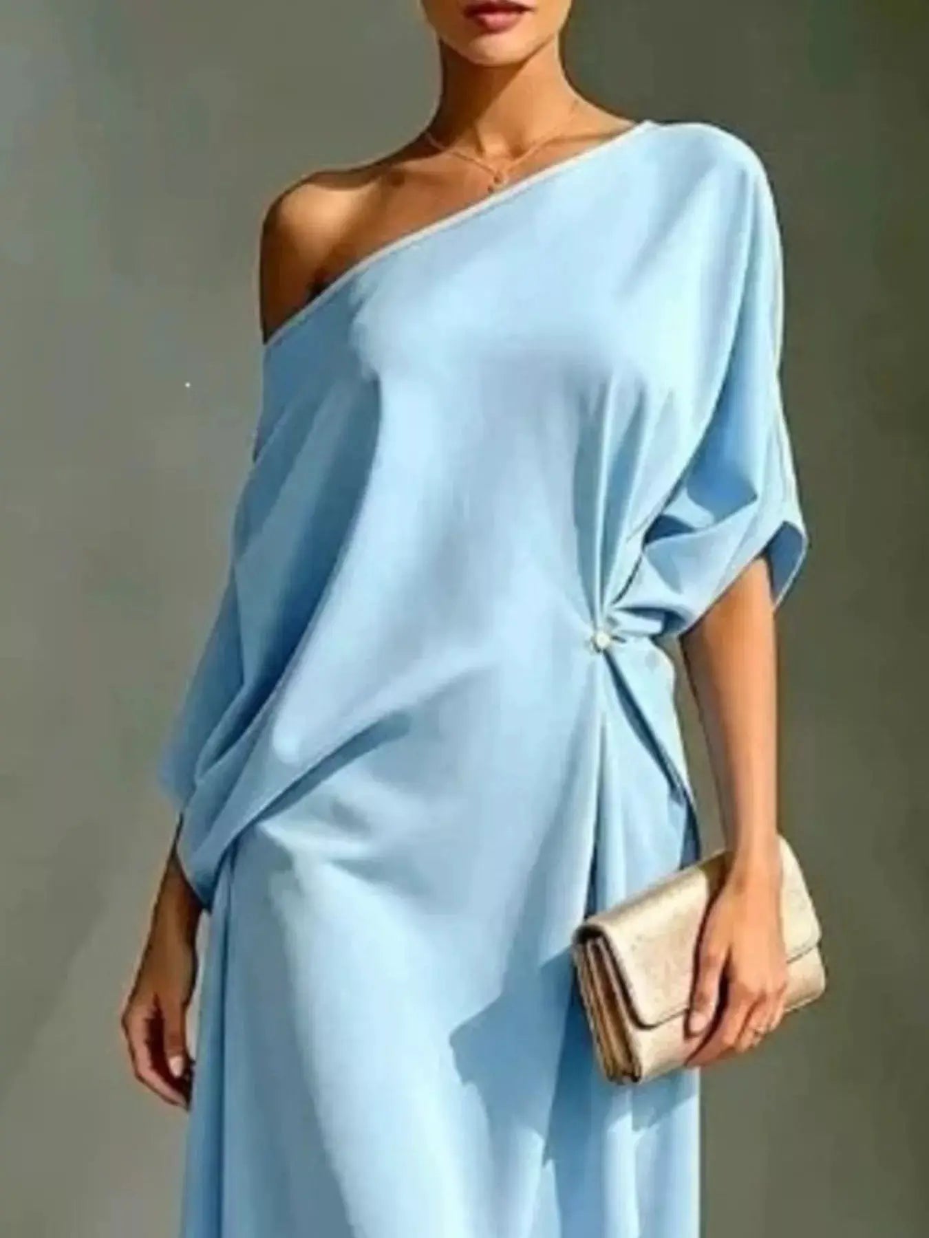 Plus size asymmetrical one-shoulder draped dress in light blue with beige clutch