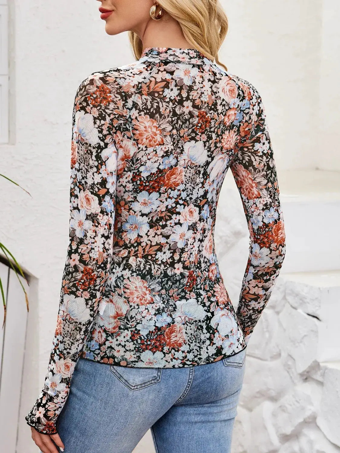 Floral mock-neck long-sleeve top in sheer fabric with pink, blue and ivory flowers on black