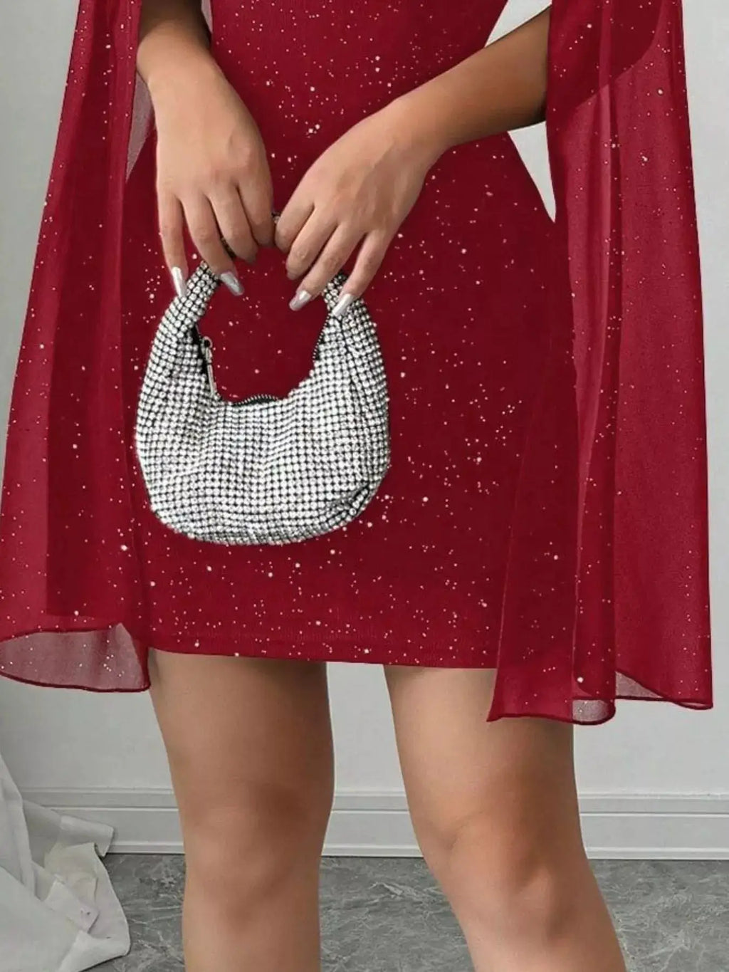 Cutout Bodycon Mini Dress with Cape Sleeves, red glitter by Belle Bijouix; paired with a beaded handbag.