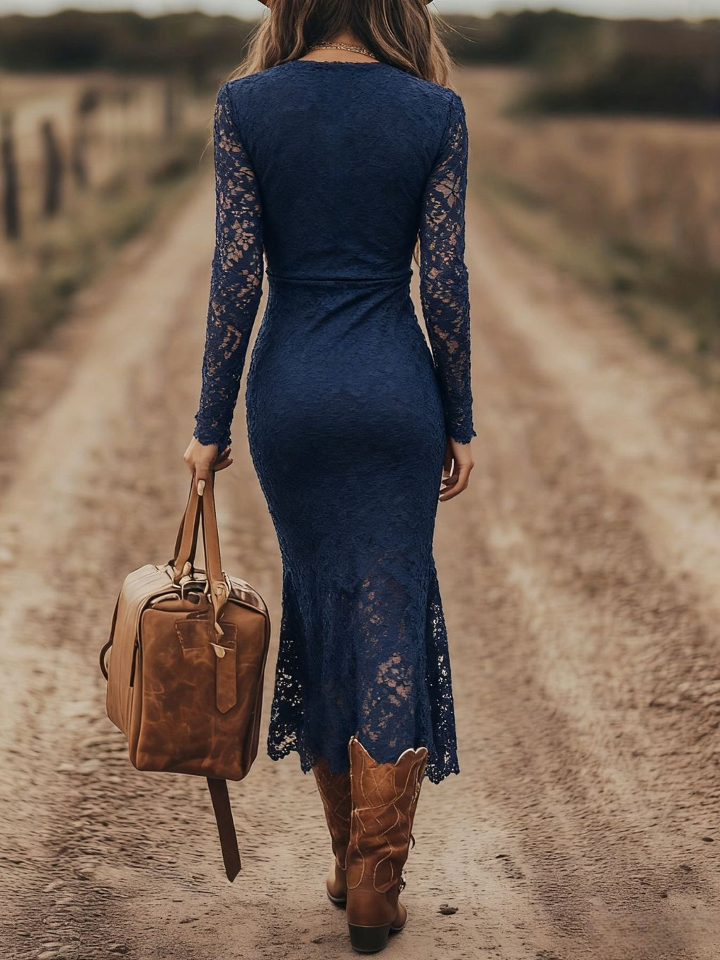 Lace long-sleeve navy midi dress; back view on model, paired with a tan leather bag.