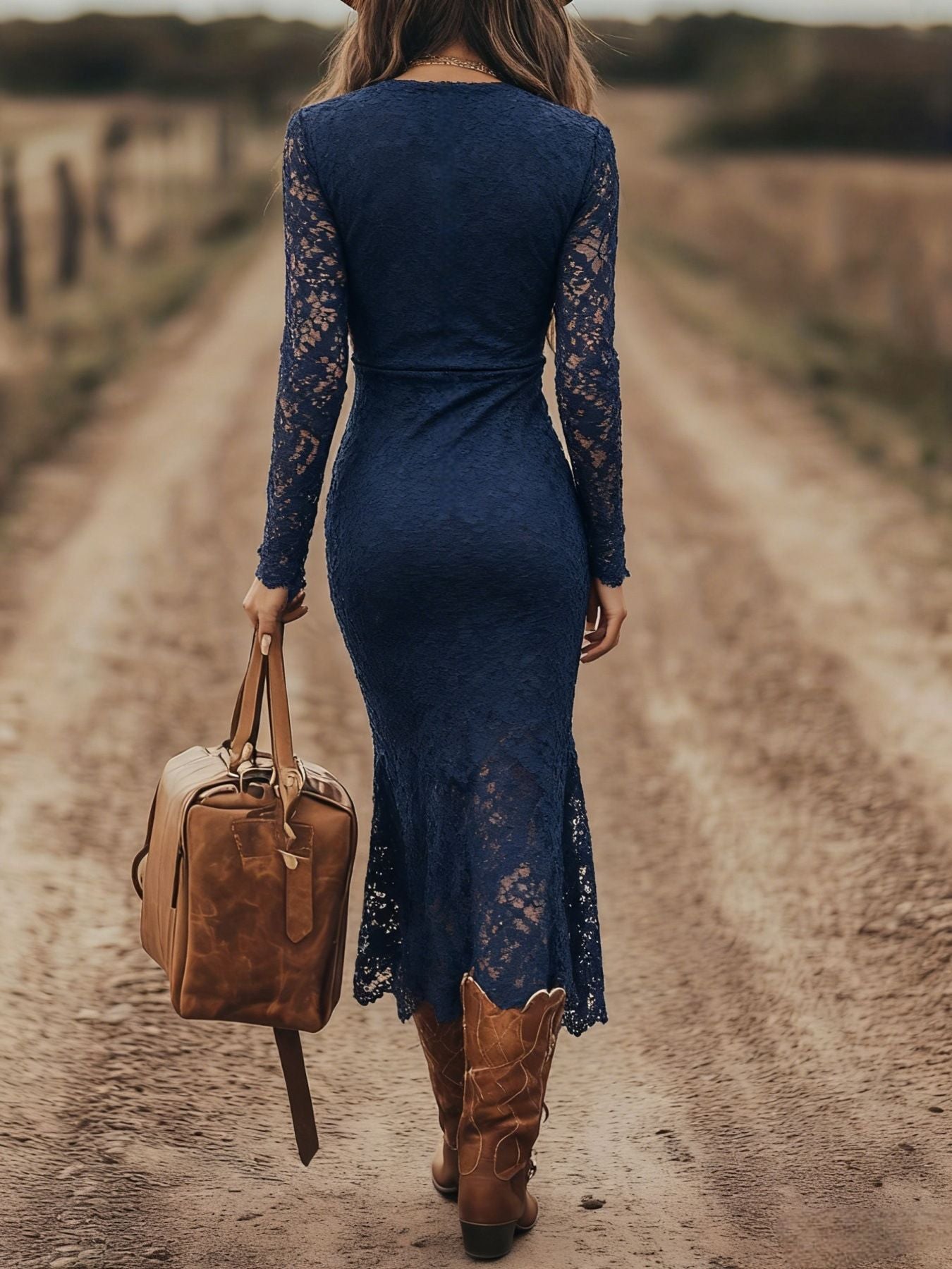 Lace long-sleeve navy midi dress; back view on model, paired with a tan leather bag.
