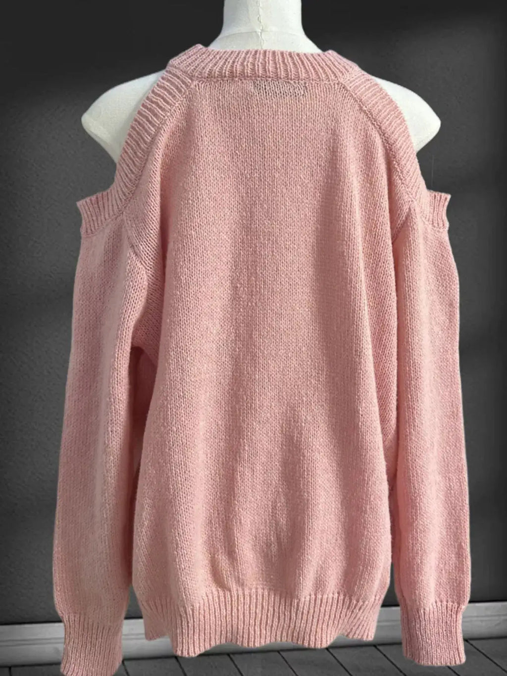 Pink cold-shoulder knit sweater with ribbed cuffs and hem, back view on mannequin