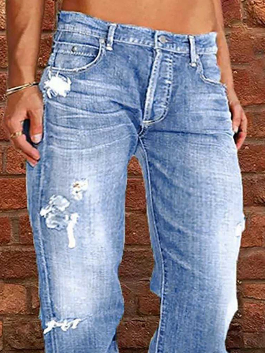 Distressed loose-fit jeans in light blue denim with ripped knees by Belle Bijouix