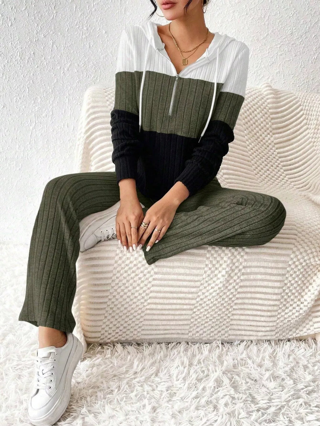 Color block ribbed knit half-zip hooded top and pants set in white, olive, and black; two-piece active loungewear.