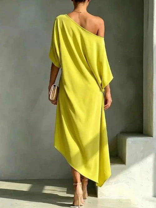 Plus-size asymmetrical one-shoulder drape dress in lime yellow, back view for evening events; nude heels