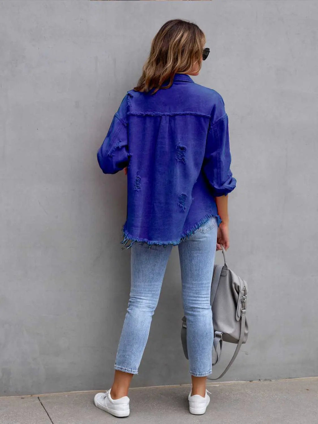 Distressed drop-shoulder denim jacket in blue indigo with frayed hem