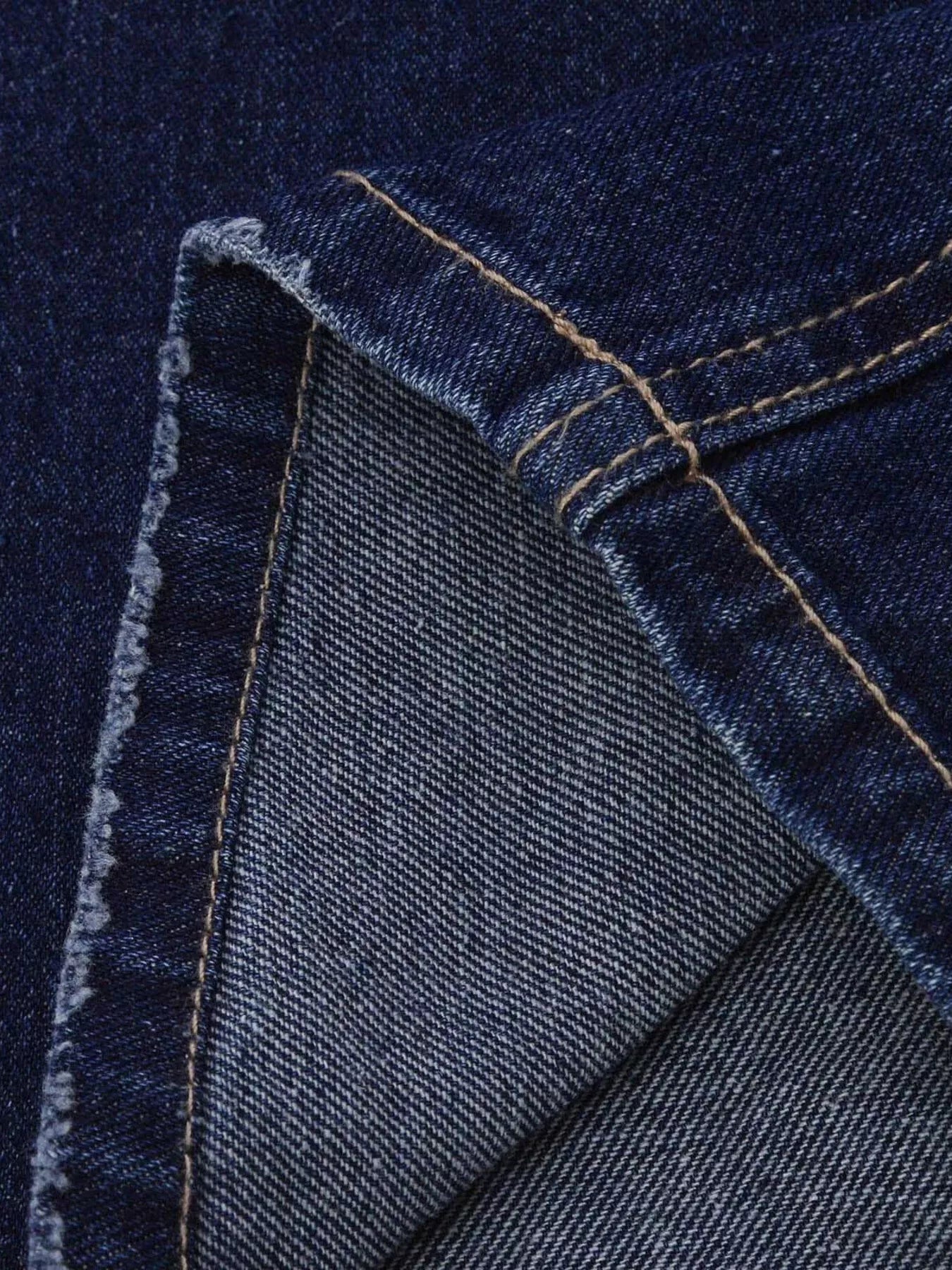 Distressed loose-fit jeans in dark blue denim with golden stitching by Belle Bijouix
