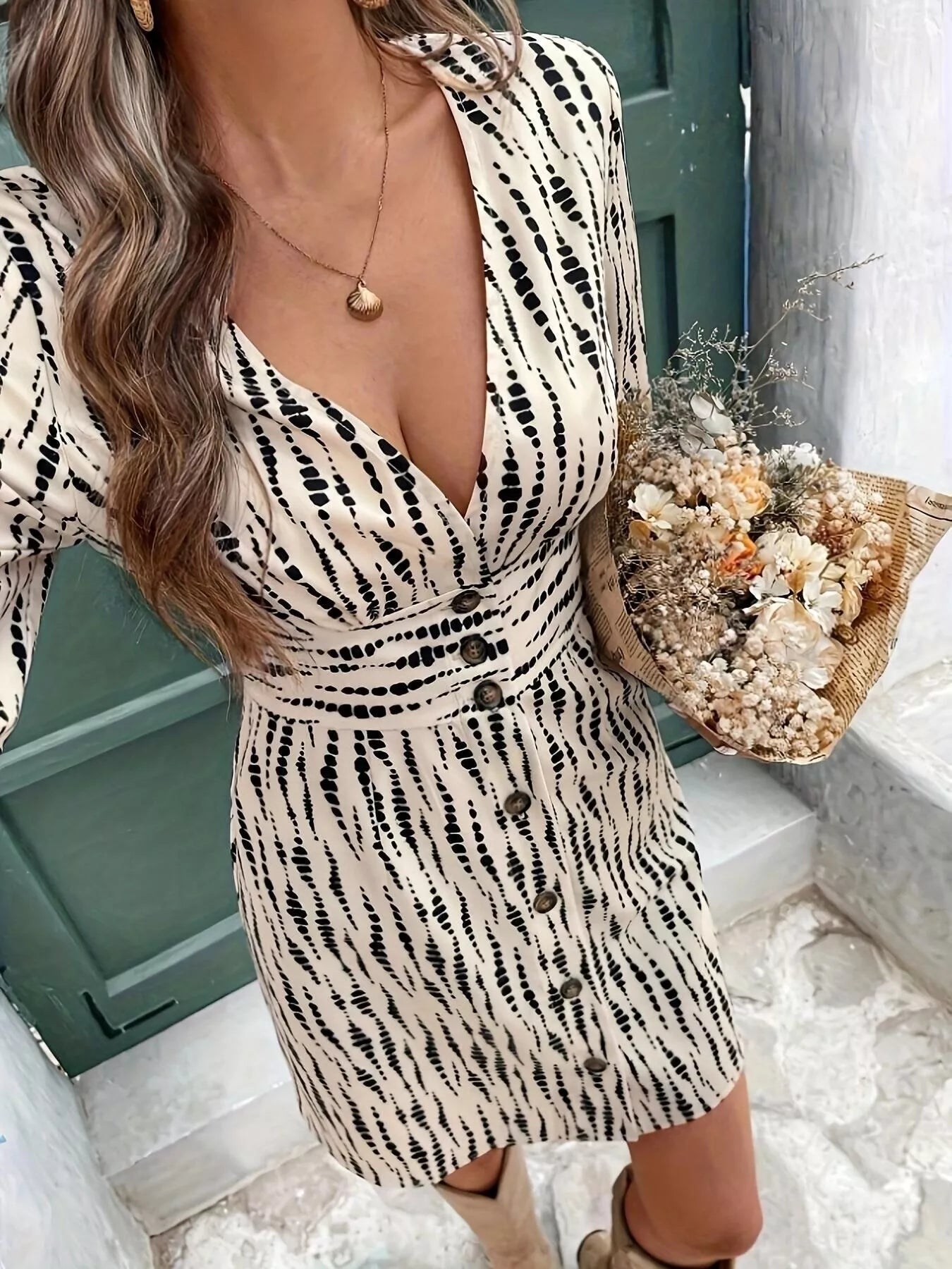 Button Front Flounce Sleeve Dress in cream with a black dotted print and button-down front.