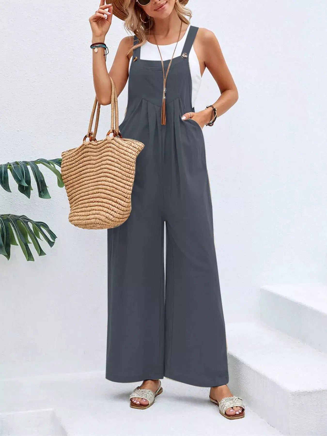 Full Size Casual Wide-Leg Overalls with Pockets Plus Size in charcoal gray, paired with a straw tote