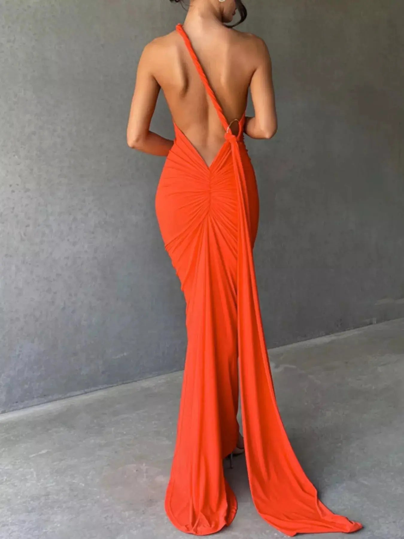 Backless One-Shoulder Ruched Bodycon Maxi Dress by Belle Bijouix in bright orange with long back drape
