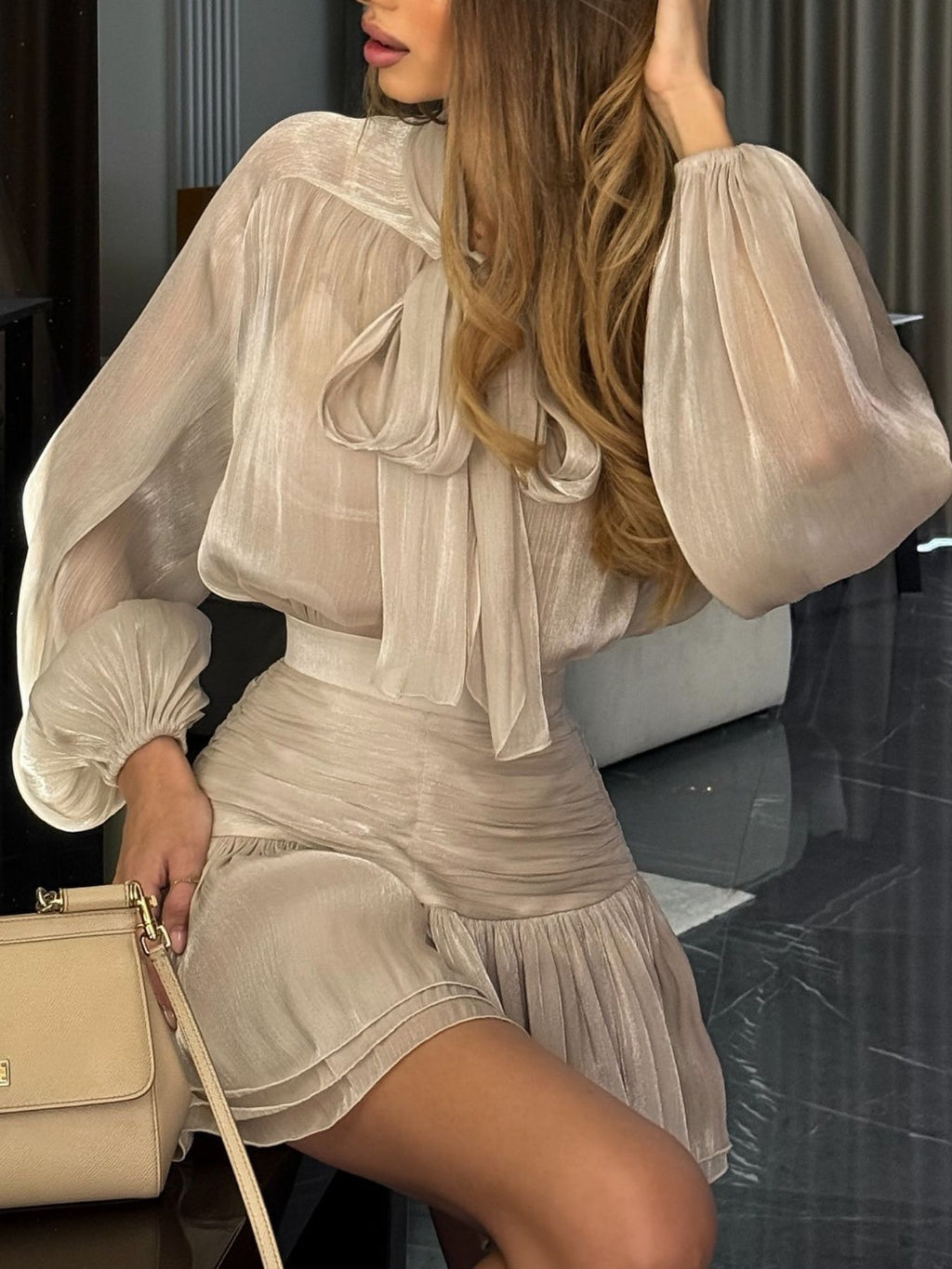 Bow-Tie Blouse and Ruched Mini Skirt Set, Trendsi; beige satin two-piece set with bishop sleeves and ruched skirt.