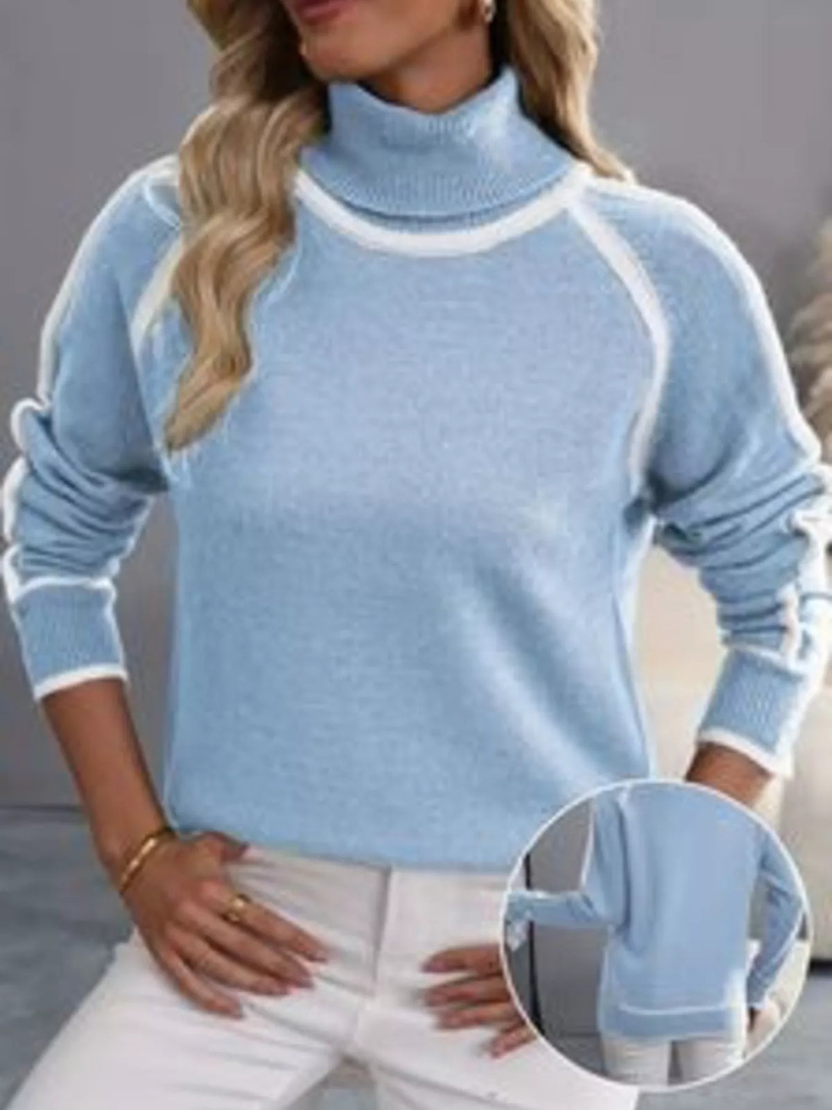Sky blue turtleneck sweater with white contrast trim and inset cuff detail