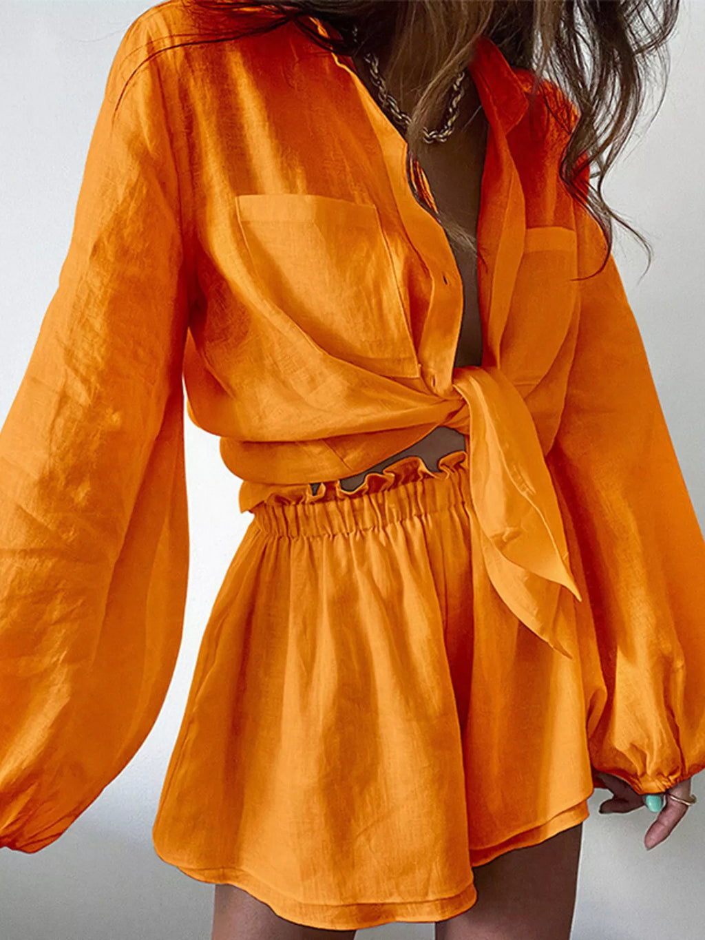 Button Up Long Sleeve Shirt and Shorts Set by Trendsi in bright orange satin with a tied waist top