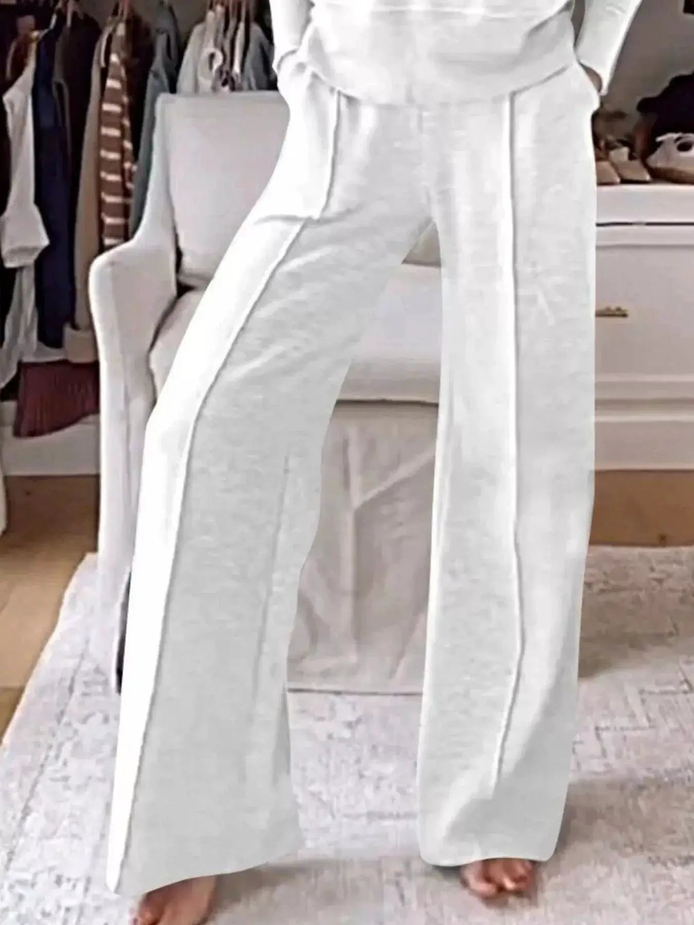 Plus-size cozy v-neck top and pants lounge set in white with pockets and full-length pants.