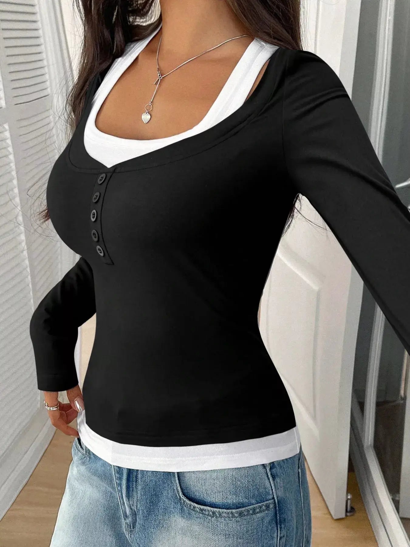 Scoop neck long sleeve black T-shirt with white underlayer and button placket