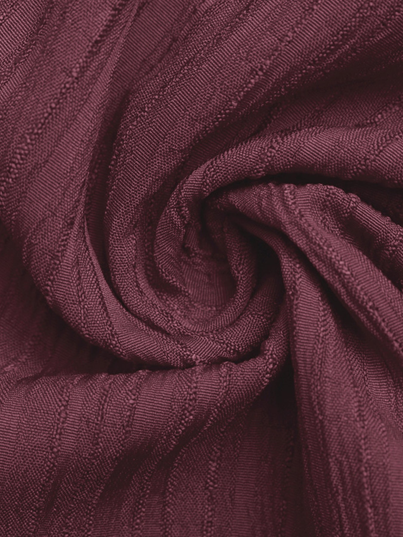 One-shoulder tie-waist romper fabric close-up in burgundy knit