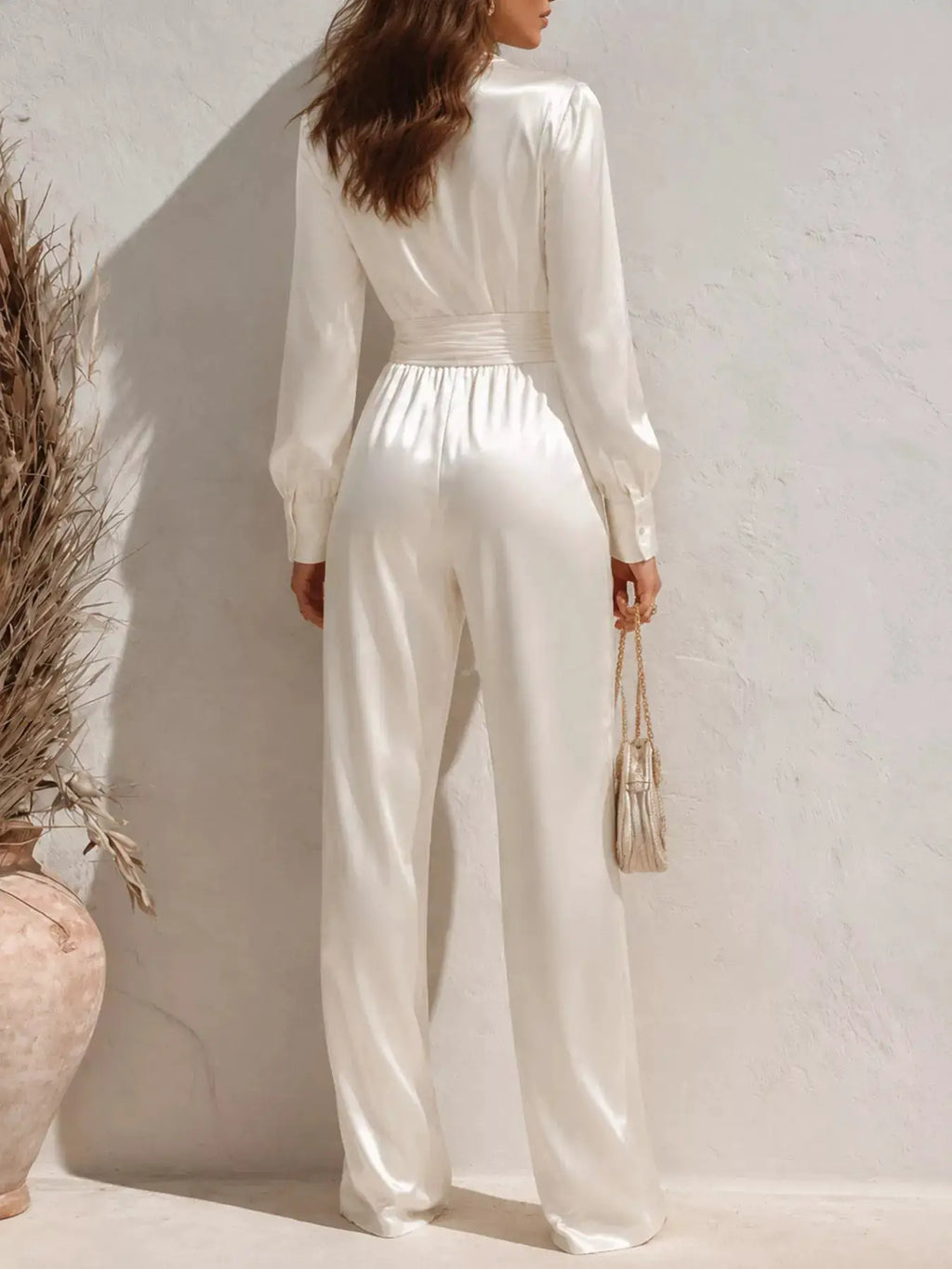 Satin long-sleeve wide-leg jumpsuit in ivory by Trendsi, back view with cinched waist.