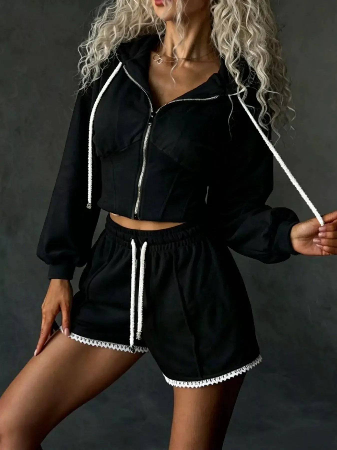 Belle Bijouix two-piece zip-up hooded activewear set: black cropped jacket with white drawstrings and lace-trim shorts